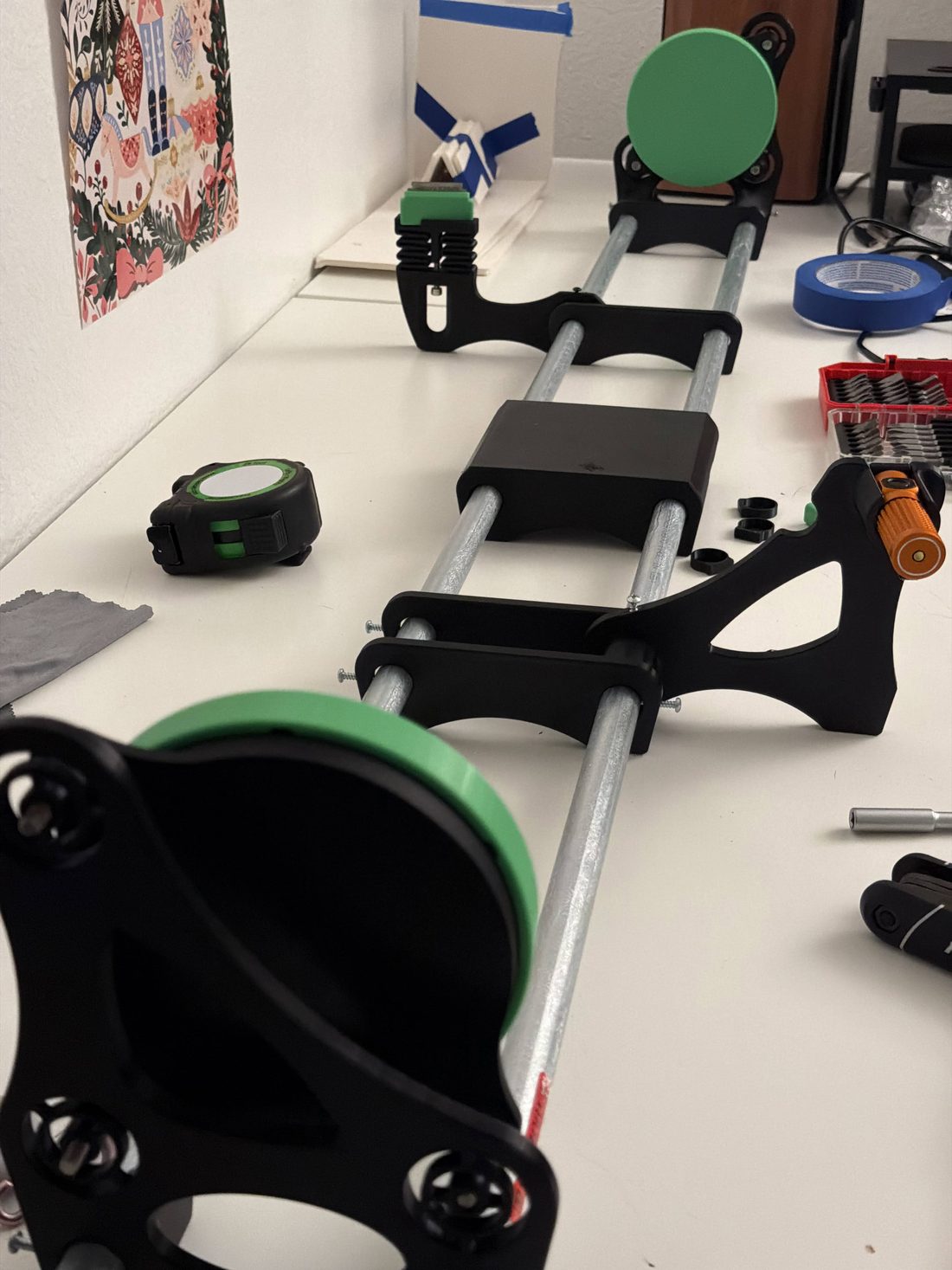 Optical rails, mounts and mirrors for a tabletop schlieren system laid out on a white table.